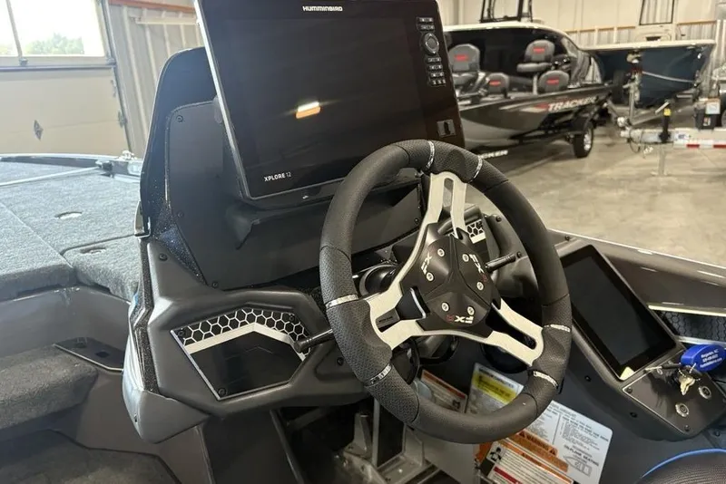Slide: The Image of 2026 Skeeter FXR20 FLEX boat dashboard with steering wheel and electronic display. - 23