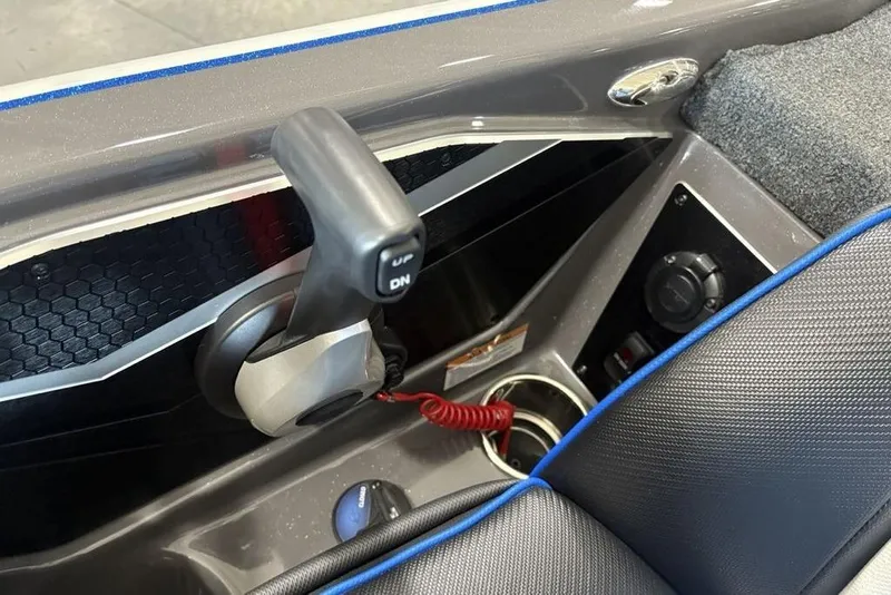 Slide: The Image of 2026 Skeeter FXR20 FLEX boat interior with control lever and cup holder. - 24