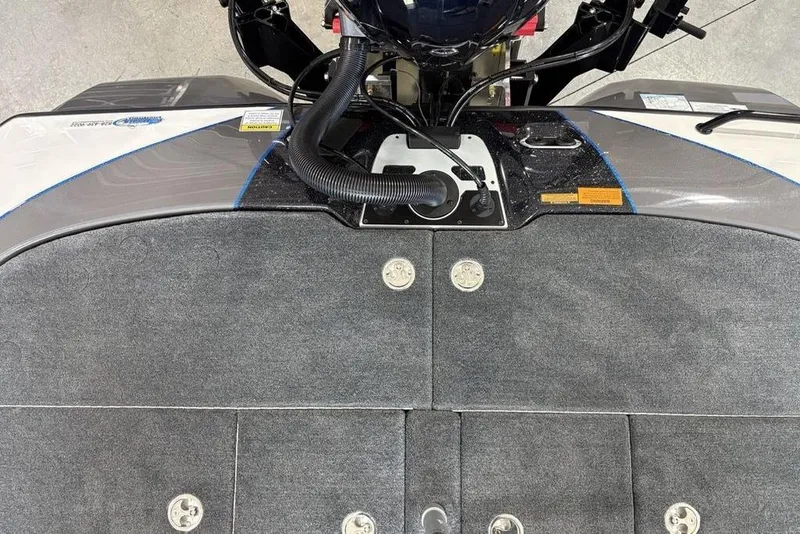 Slide: The Image of 2026 Skeeter FXR20 FLEX boat deck with carpeted surface and engine components. - 33