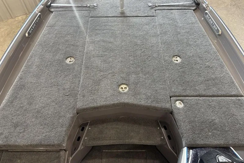 Slide: The Image of 2026 Skeeter FXR20 FLEX boat deck with gray carpet and storage compartments. - 7