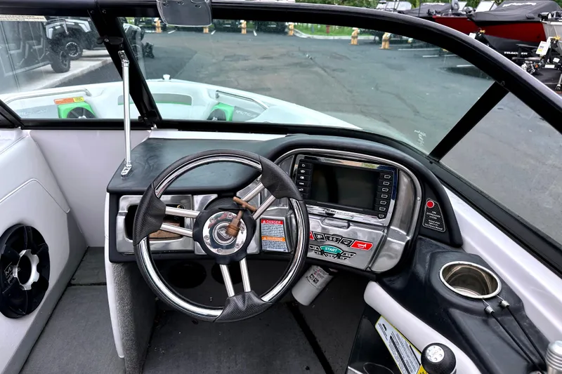 Slide: The Image of 2012 Nautique Sport Nautique 200 boat dashboard with steering wheel and control panel. - 10