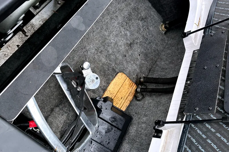 Slide: The Image of 2012 Nautique Sport Nautique 200 interior, showcasing engine compartment details and components. - 13