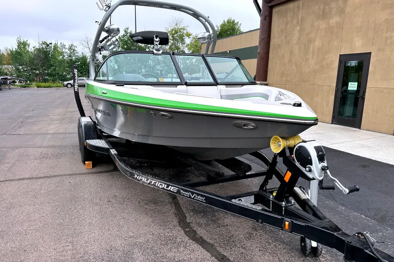 Slide: The Image of 2012 Nautique Sport Nautique 200 boat on trailer, parked outdoors. - 21