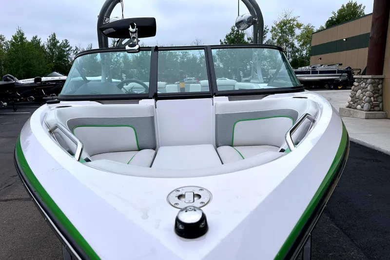 Slide: The Image of 2012 Nautique Sport Nautique 200 boat with white and green interior, parked outdoors. - 4