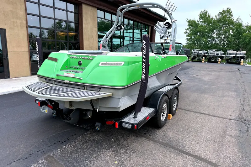 Slide: The Image of 2012 Nautique Sport Nautique 200 boat in vibrant green on a trailer. - 5