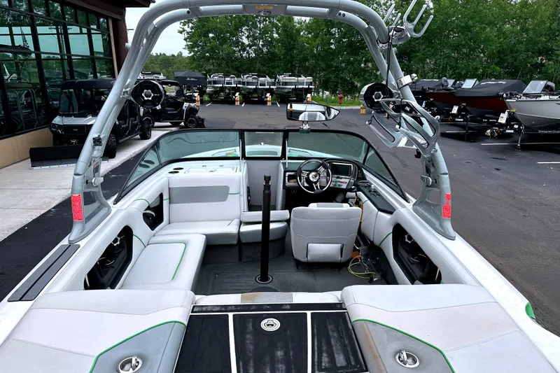 Slide: The Image of 2012 Nautique Sport Nautique 200 boat interior with seating and steering wheel. - 9
