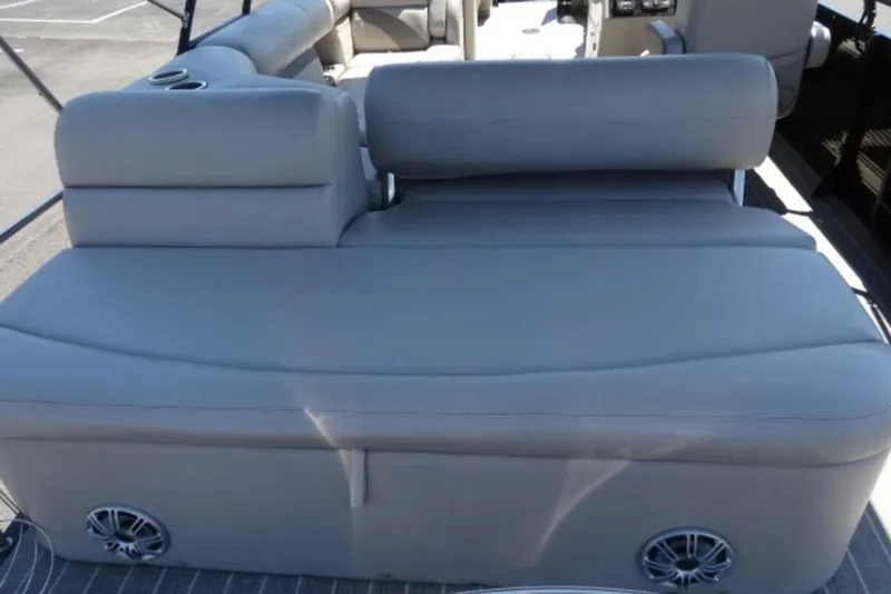 Slide: The Image of 2017 Harris Sunliner 240 boat interior with gray seating and built-in speakers. - 10