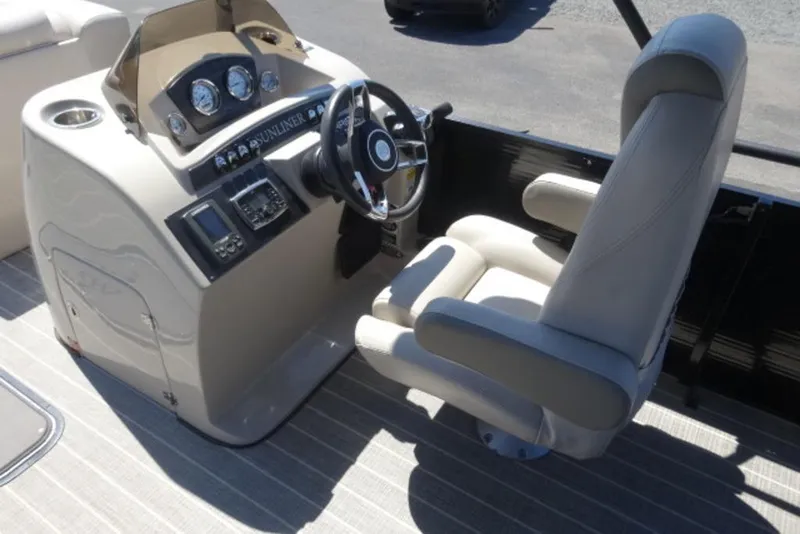 Slide: The Image of 2017 Harris Sunliner 240 boat helm with steering wheel and control panel. - 5