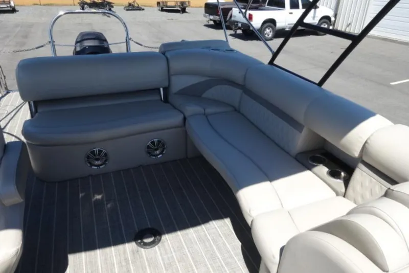 Slide: The Image of 2017 Harris Sunliner 240 pontoon boat interior with gray seating and cup holders. - 9
