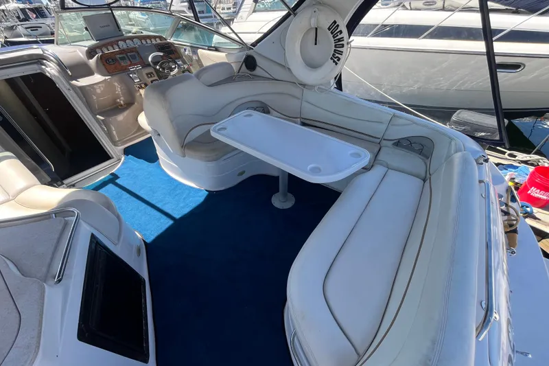 Slide: The Image of 2005 Larson-Cabrio 370 boat interior with white seating and blue carpet. - 12