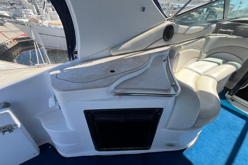 Slide: The Image of 2005 Larson-Cabrio 370 boat interior with white seating and blue carpet. - 14
