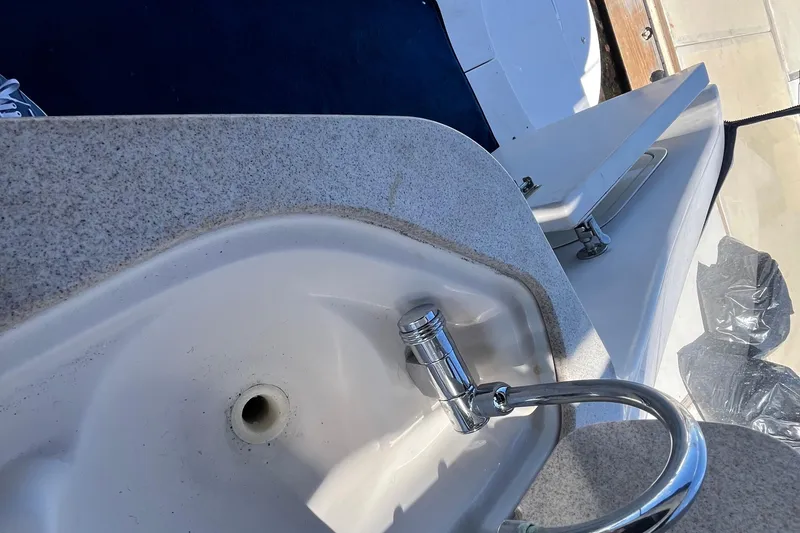 Slide: The Image of 2005 Larson-Cabrio 370 boat sink with chrome faucet and countertop detail. - 16