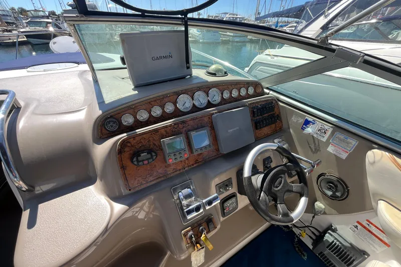 Slide: The Image of Cockpit of 2005 Larson-Cabrio 370 boat with Garmin navigation system and control panel. - 17