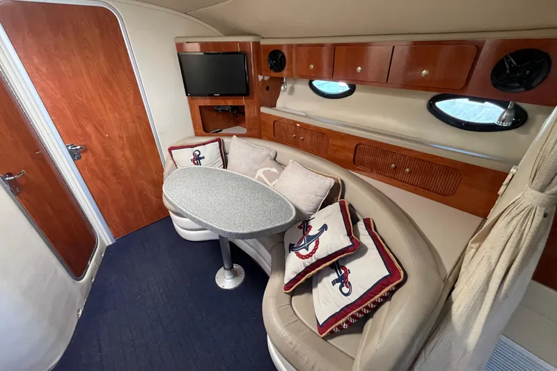 Slide: The Image of Interior of a 2005 Larson-Cabrio 370 boat with cozy seating and nautical decor. - 21