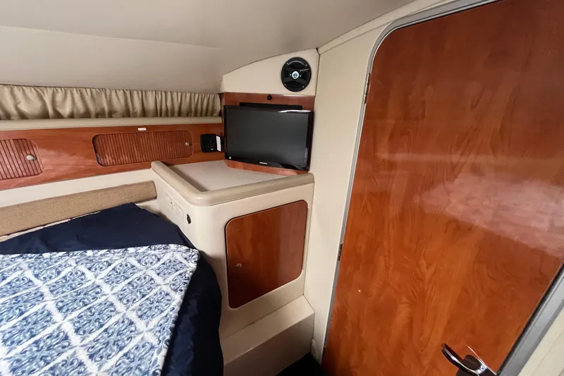 Slide: The Image of 2005 Larson-Cabrio 370 cabin interior with wood paneling and TV. - 26