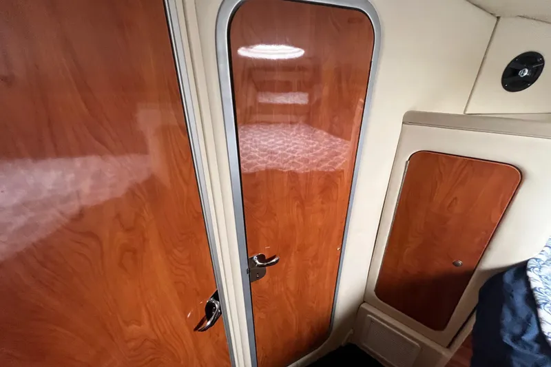 Slide: The Image of Interior cabin of 2005 Larson-Cabrio 370 with wooden doors and modern design. - 29