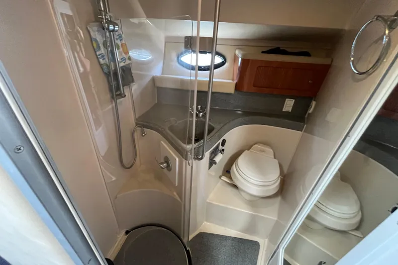 Slide: The Image of 2005 Larson-Cabrio 370 yacht bathroom with shower, toilet, and sink. - 30