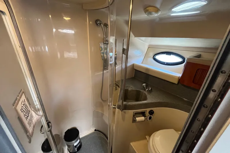 Slide: The Image of 2005 Larson-Cabrio 370 boat bathroom with shower, sink, and toilet. - 31