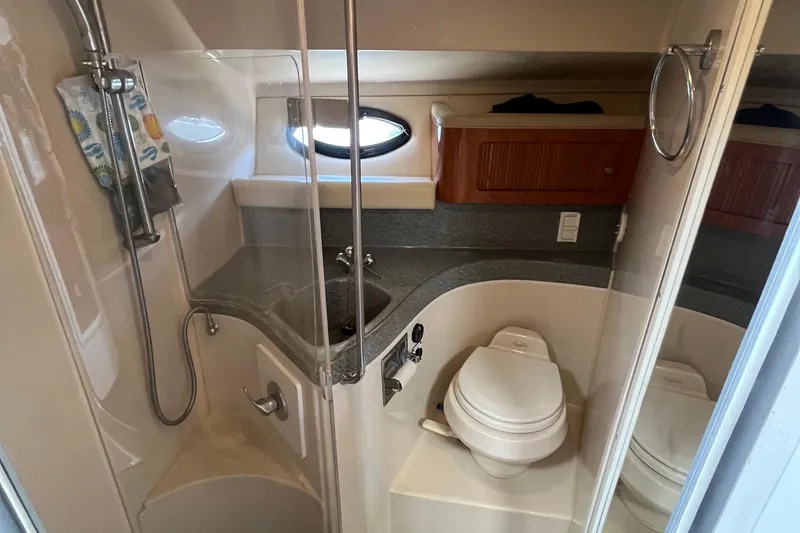 Slide: The Image of 2005 Larson-Cabrio 370 boat bathroom with shower, sink, and toilet. - 32