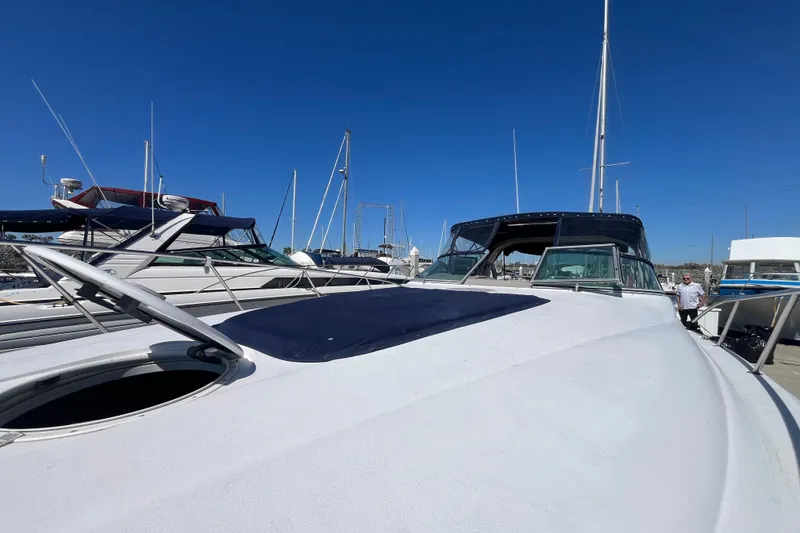 Slide: The Image of 2005 Larson-Cabrio 370 yacht docked at marina under clear blue sky. - 6