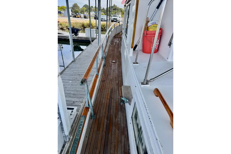Slide: The Image of 1978 Grand Banks Classic yacht with wooden deck and dockside view. - 16