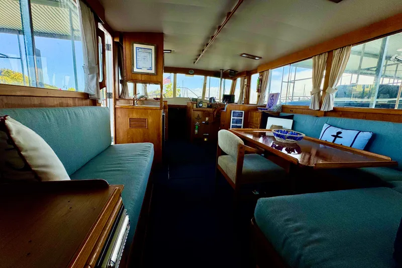 Slide: The Image of Interior of a 1978 Grand Banks Classic yacht with cozy seating and wooden accents. - 21