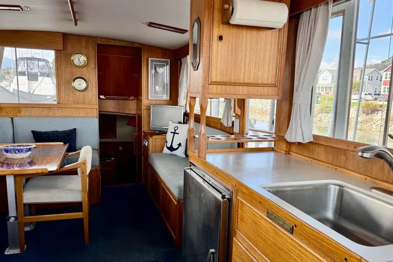 Slide: The Image of Interior of a 1978 Grand Banks Classic boat with wood finish and nautical decor. - 22