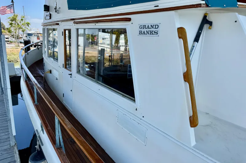 Slide: The Image of 1978 Grand Banks Classic yacht with wooden railings docked at marina. - 3