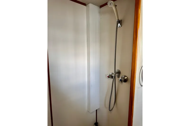 Slide: The Image of Shower area in 1978 Grand Banks Classic boat with handheld showerhead and controls. - 31