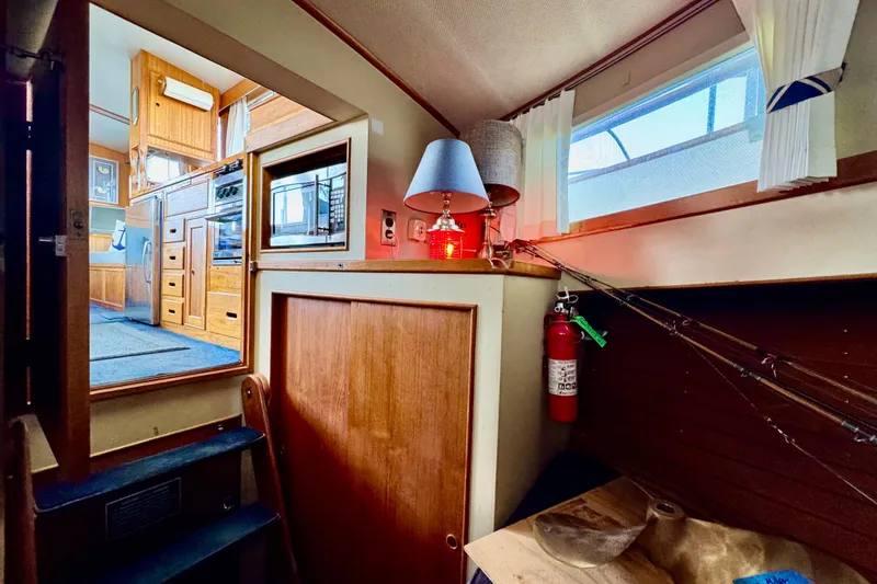 Slide: The Image of 1978 Grand Banks Classic interior with wooden cabinetry, lamp, and fire extinguisher. - 33