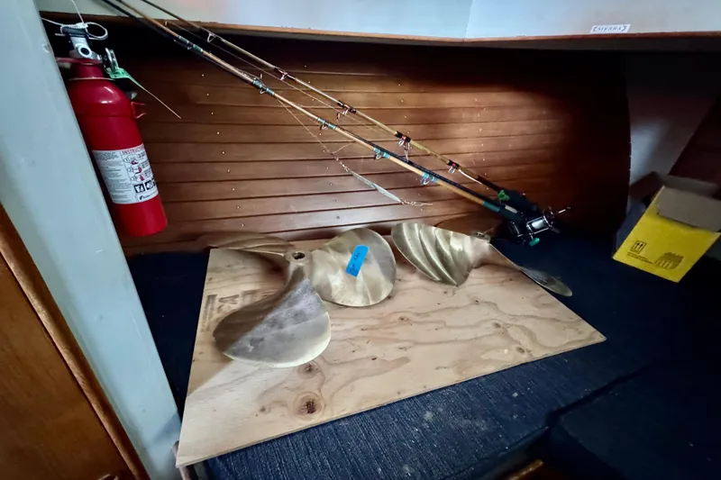 Slide: The Image of 1978 Grand Banks Classic interior with fishing rods, propeller, and fire extinguisher. - 34
