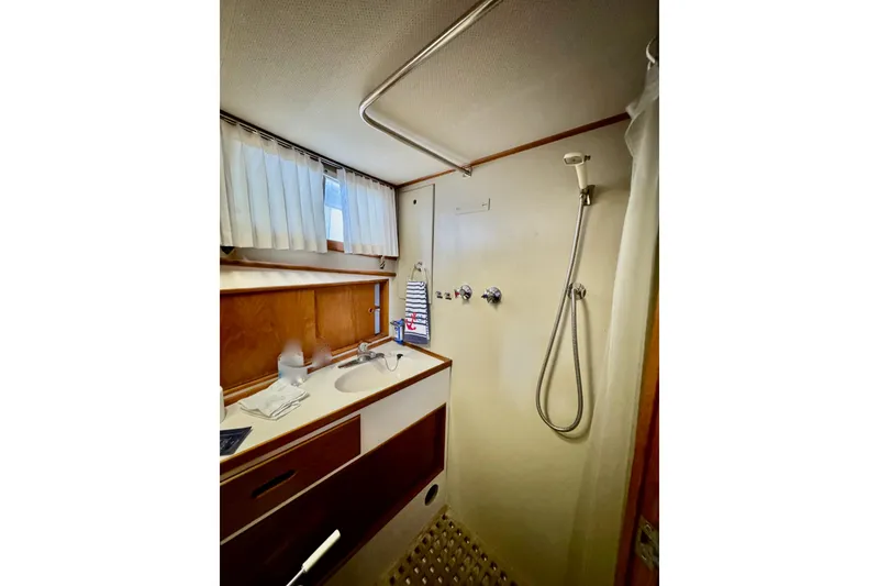 Slide: The Image of 1978 Grand Banks Classic yacht bathroom with shower, sink, and wooden cabinetry. - 36