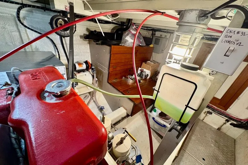 Slide: The Image of Engine room of a 1978 Grand Banks Classic boat with fuel tank and maintenance equipment. - 37
