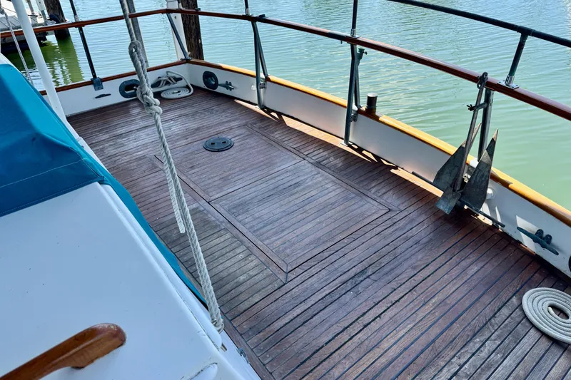 Slide: The Image of 1978 Grand Banks Classic boat deck with wooden flooring and nautical equipment. - 4