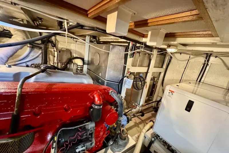 Slide: The Image of Engine room of a 1978 Grand Banks Classic boat, featuring a red engine and various mechanical components. - 41