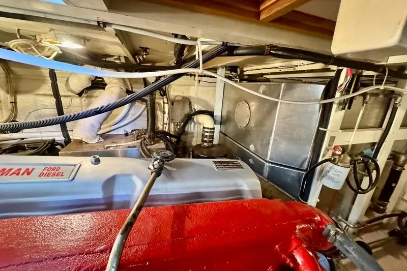 Slide: The Image of Engine room of a 1978 Grand Banks Classic boat with Ford diesel engine. - 42