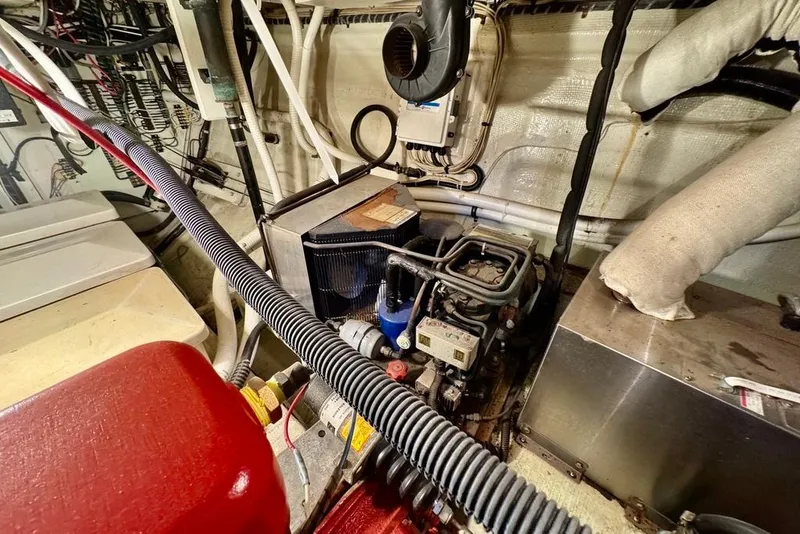 Slide: The Image of Engine room of a 1978 Grand Banks Classic boat, showcasing mechanical components and wiring. - 44