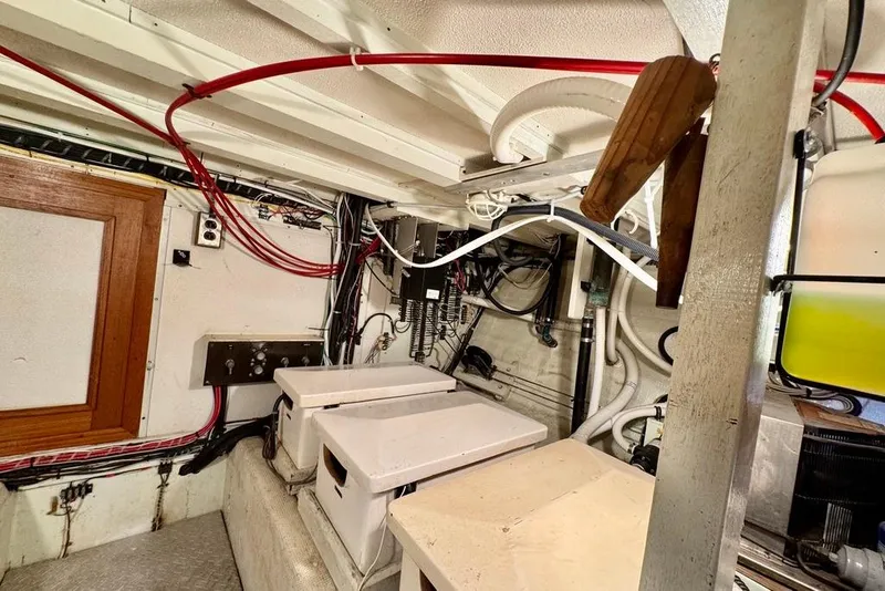 Slide: The Image of Engine room of a 1978 Grand Banks Classic boat with wiring and equipment. - 46