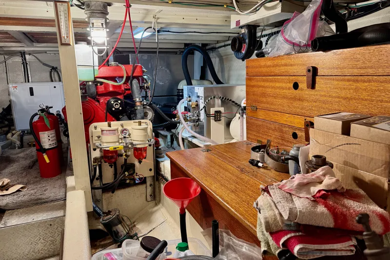 Slide: The Image of Engine room of a 1978 Grand Banks Classic boat with tools and equipment. - 48