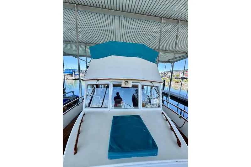 Slide: The Image of 1978 Grand Banks Classic yacht docked under a covered marina. - 57