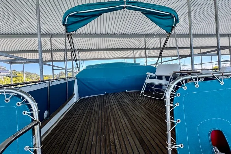 Slide: The Image of 1978 Grand Banks Classic yacht deck with blue canopy and seating under covered dock. - 59