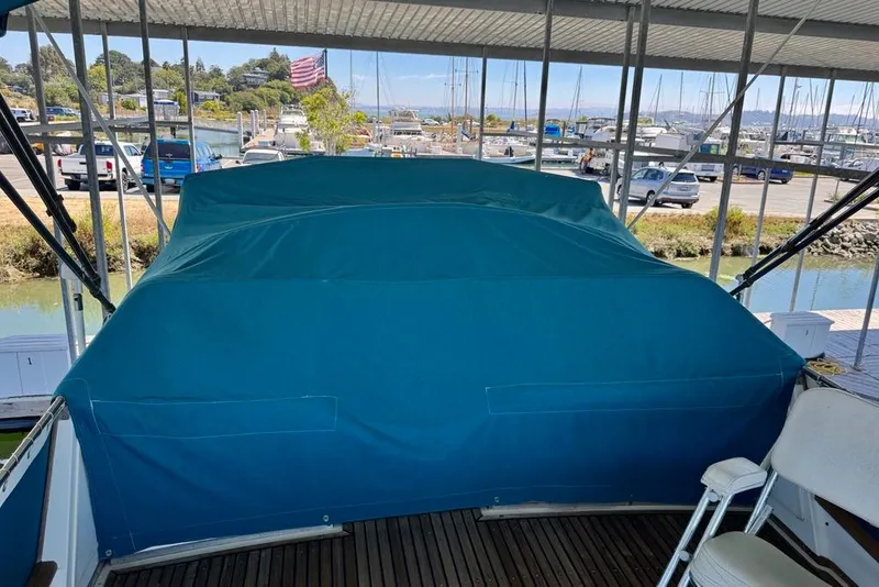 Slide: The Image of 1978 Grand Banks Classic boat covered in blue tarp at marina dock. - 60
