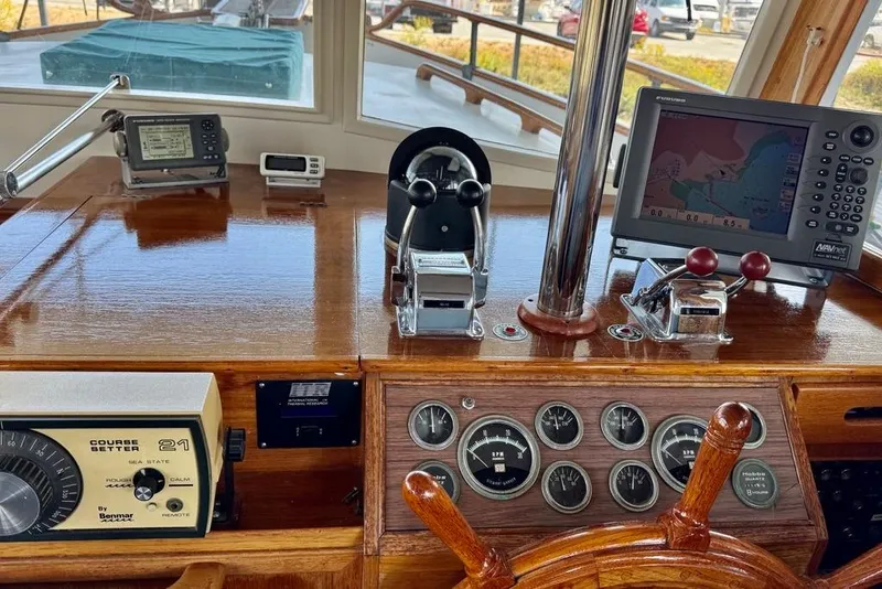 Slide: The Image of 1978 Grand Banks Classic helm with navigation instruments and wooden steering wheel. - 63