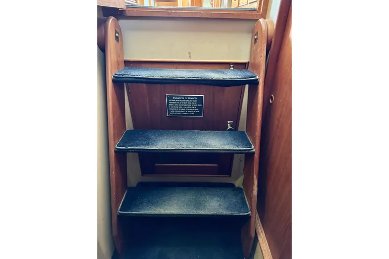 Slide: The Image of Staircase inside 1978 Grand Banks Classic boat with wooden finish and carpeted steps. - 71
