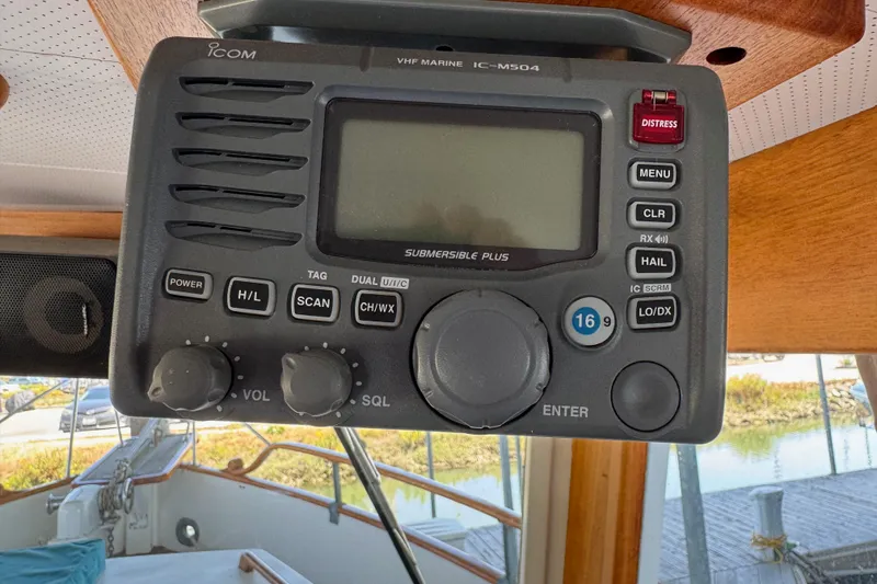 Slide: The Image of VHF marine radio on 1978 Grand Banks Classic boat, featuring distress button and control knobs. - 74