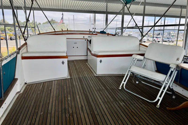 Slide: The Image of 1978 Grand Banks Classic yacht interior with wooden deck and white seating. - 9