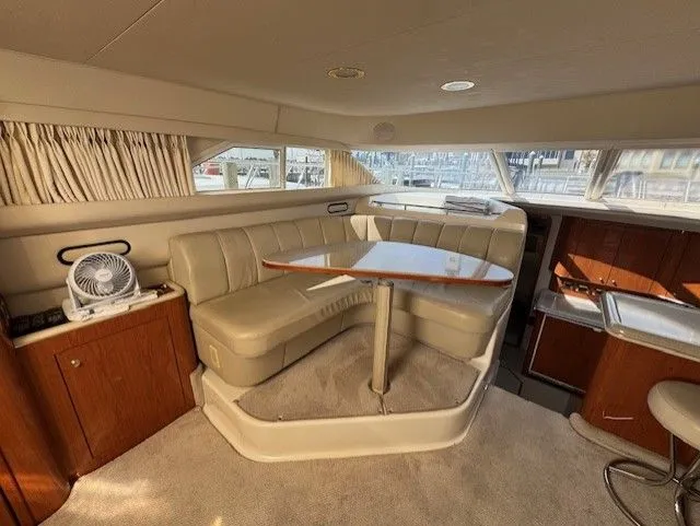 Slide: The Image of Luxurious interior of 1999 Sea Ray 420 Aft Cabin yacht with plush seating and elegant decor. - 13