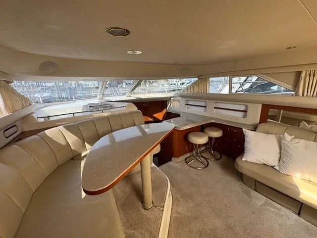Slide: The Image of Luxurious interior of a 1999 Sea Ray 420 Aft Cabin yacht with elegant seating and decor. - 14