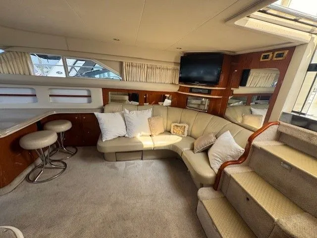 Slide: The Image of Luxurious 1999 Sea Ray 420 Aft Cabin interior with elegant bedroom and modern amenities. - 15