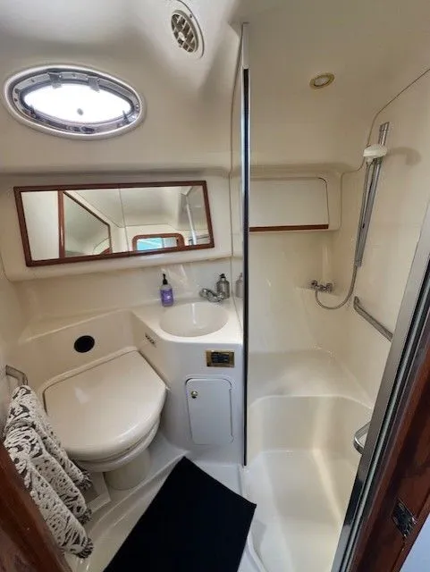 Slide: The Image of Luxurious 1999 Sea Ray 420 Aft Cabin interior with elegant bedding and wood cabinetry. - 16